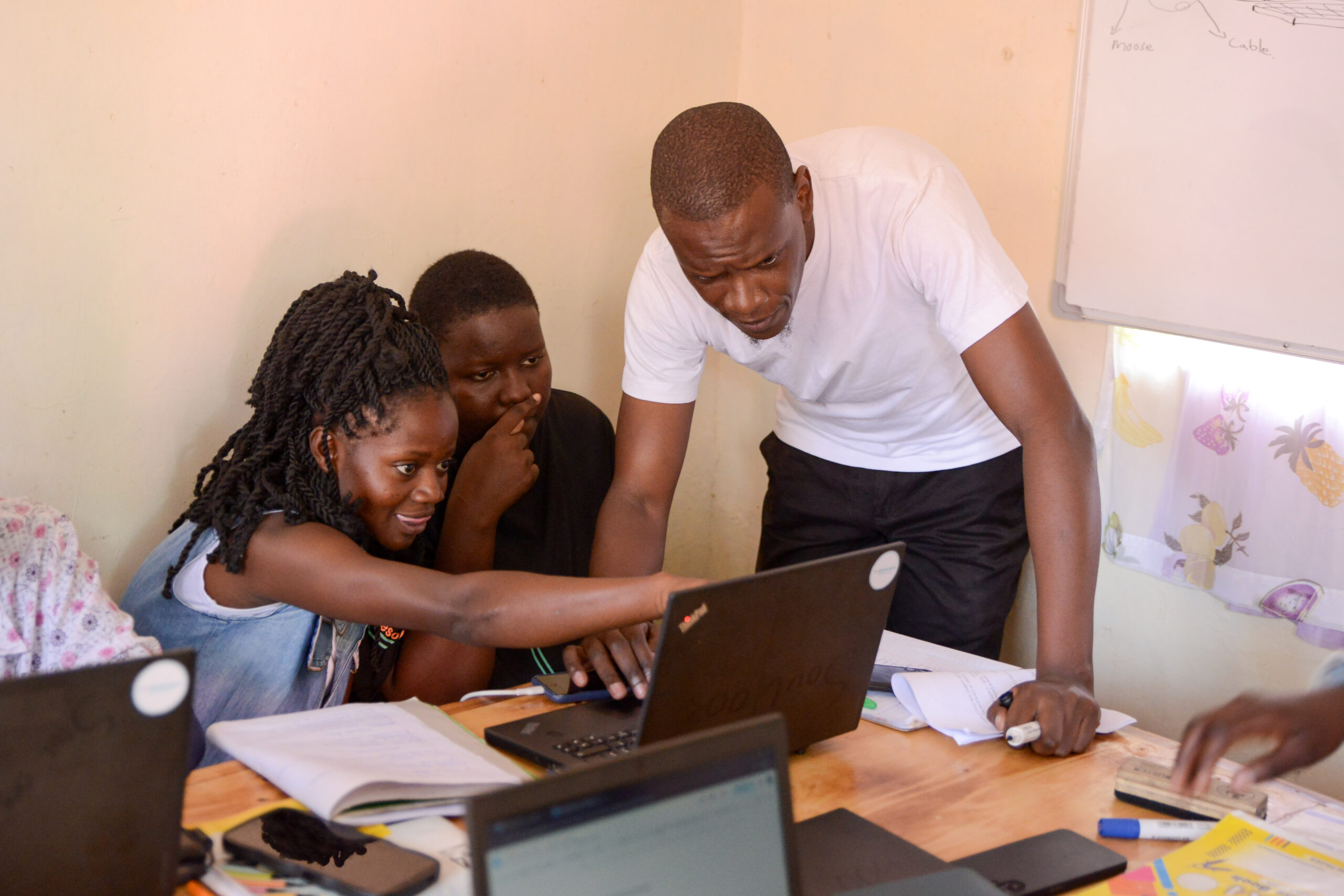 Kizito Omollo, lead trainer for the Okiri Digital Literacy Project, engages with participants during a class